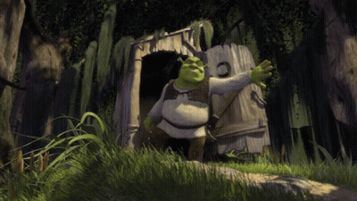 Shrek Is Standing In Front Of A Wooden Shack In The Woods GIF