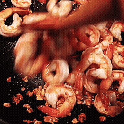 Shrimp Being Cooked In Pan With Wooden Spoon GIF