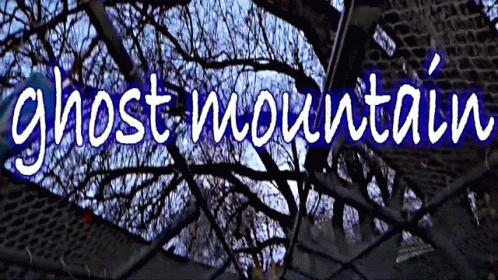 Sign Saying Ghost Mountain With Brick Building GIF