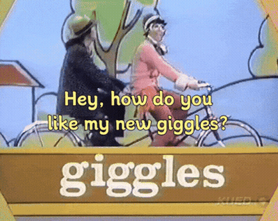 Sign Saying Giggles With Two People Riding Bicycles GIF