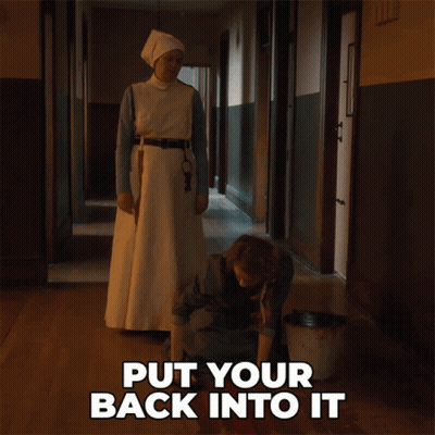 Sign Saying Put Your Back Into It Beside Woman GIF