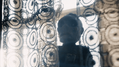 Silhouette Behind Crocheted Curtain GIF