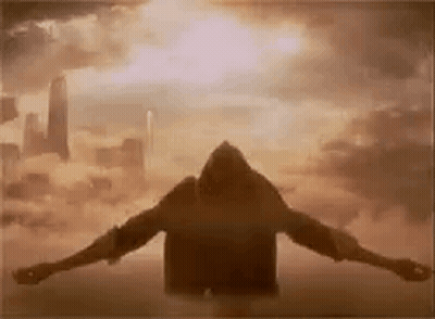 Silhouette Man Arms Outstretched In Sky GIF