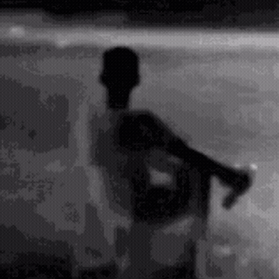Silhouette Man On Beach Holding Soda GIF