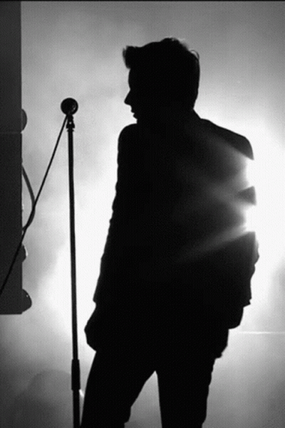 Silhouette Man Singing Into Microphone GIF