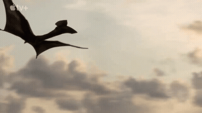 Silhouette Of Dragon Flying Through Sky GIF