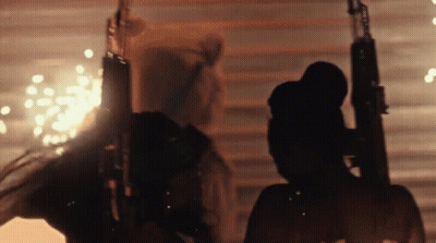 Silhouette Of Man Holding Gun With Fireworks GIF