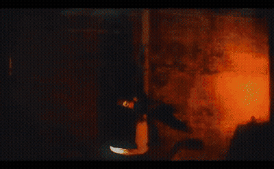 Silhouette Of Man In Front Of Orange And White Painting GIF