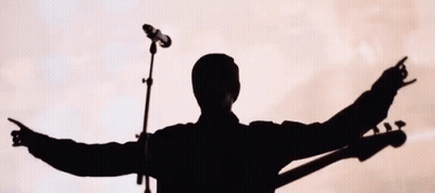 Silhouette Of Man Singing Into Microphone GIF