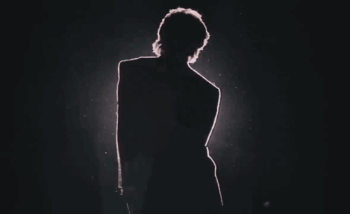 Silhouette Of Person In Dark Room With Red Light GIF