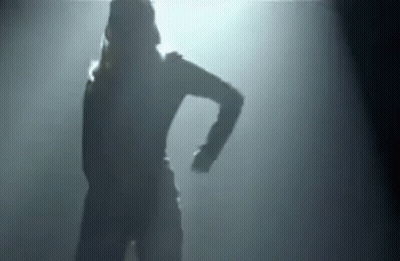 Silhouette Of Woman Dancing In Dark Room With Light GIF
