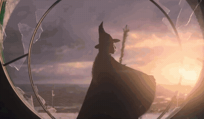 Silhouette Of Woman In Witch Costume At Sunset GIF