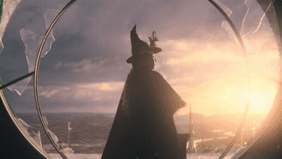 Silhouette Of Woman In Witch Hat Looking Out Window GIF