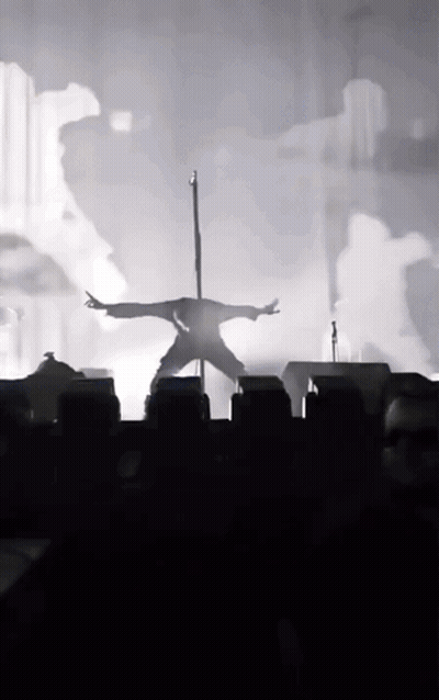 Silhouette Person On Pole Arms Outstretched GIF