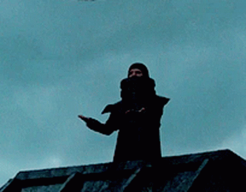 Silhouette Standing On Roof With Blue Sky GIF
