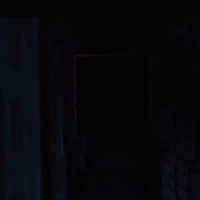 Silhouette Walking Through Dark Hallway GIF