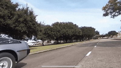 Silver Car Driving Down Road With Trees GIF