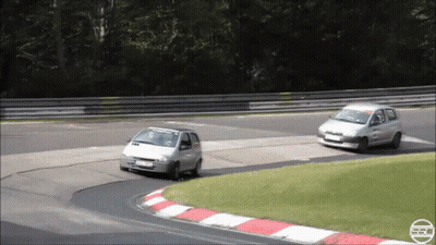 Silver Car Driving On Road With Hedge Behind GIF
