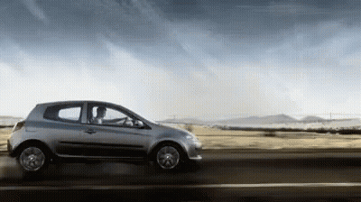 Silver Car Driving Under Cloudy Sky