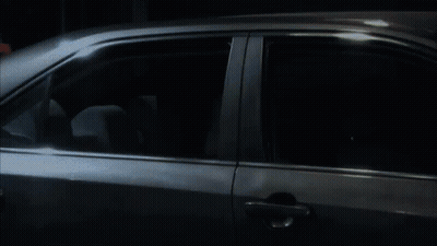 Silver Car Parked In Dark Room With Open Door GIF