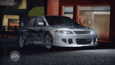 Silver Car Parked In Front Of Building With EA Letters GIF