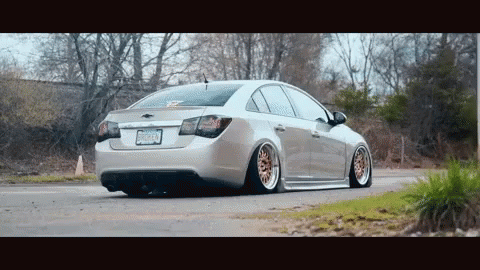 Silver Car With New Jersey License Plate Driving Down Road GIF