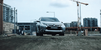 Silver Mitsubishi Driving Down Gravel Road