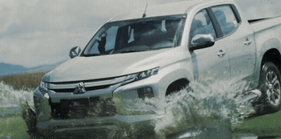 Silver Mitsubishi Truck Driving Through Puddle GIF