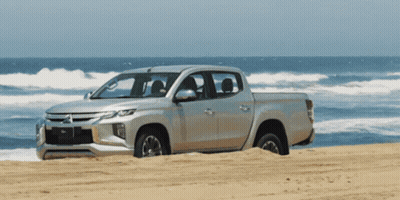 Silver Mitsubishi Truck On Sandy Beach GIF