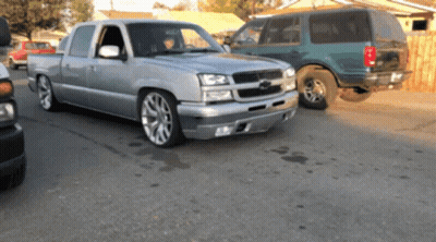 Silver Pickup Truck Next To Green Van GIF
