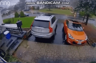 Silver SUV And Orange Car Parked In Driveway GIF