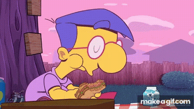 Simpsons Character At Desk With Notebook In Front Of Group GIF