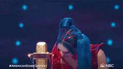 Singer Raising A Trophy GIF