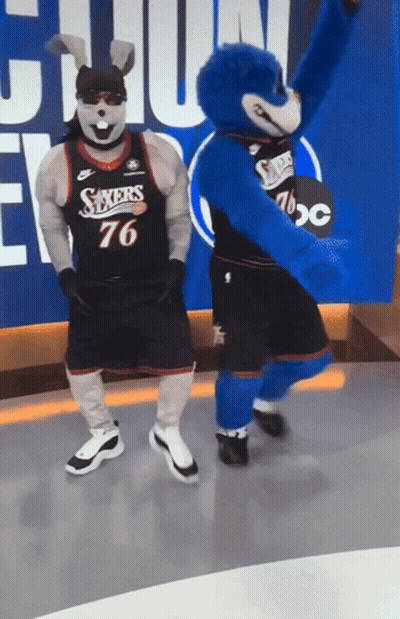Sixers Mascots Dancing In Front Of ABC Sign GIF