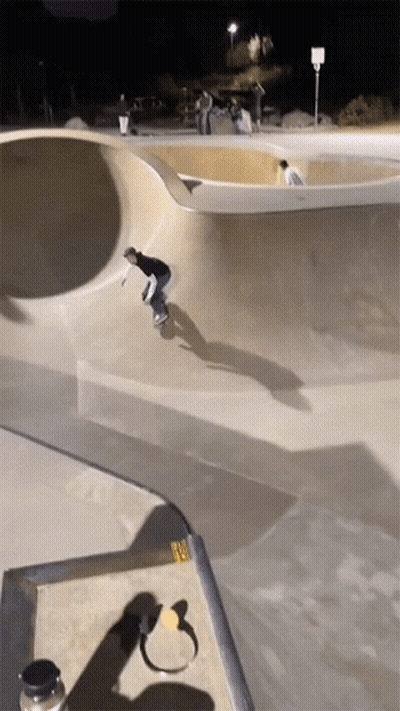 Skateboarder Doing Trick At Night GIF