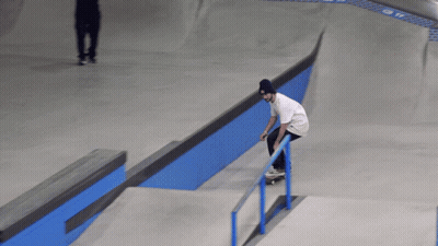 Skateboarder Doing Trick on Blue Railing