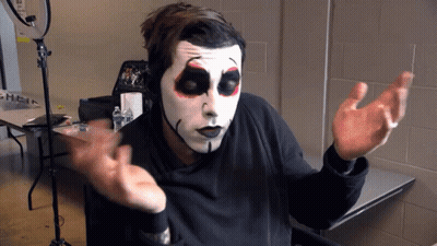 Skeleton Face Man Sitting At Table GIF