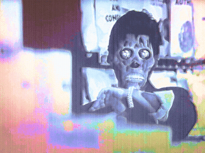 Skeleton Holding Sign Saying Comi GIF