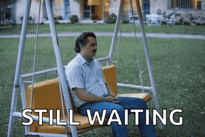 Skeleton Sitting At Table Saying Still Waiting GIF