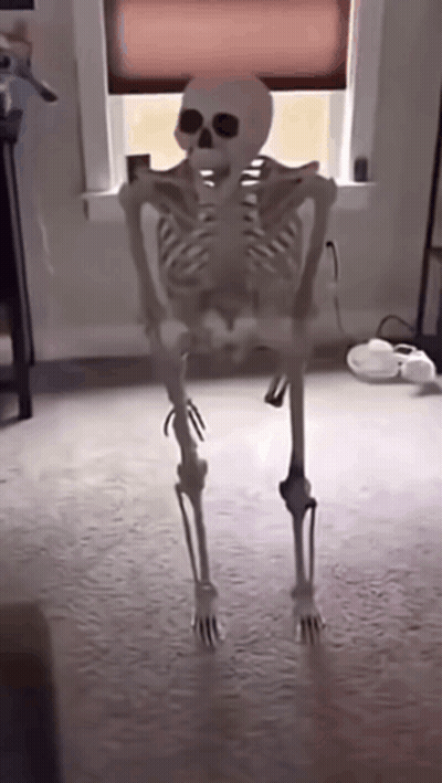 Skeleton Standing In Front Of Window GIF