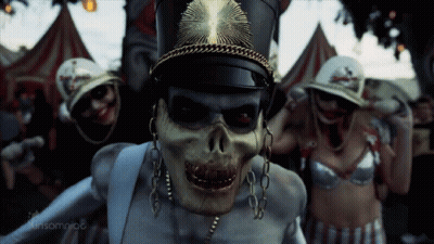 Skeleton Wearing Hat And Chains Surrounded By Skeletons GIF