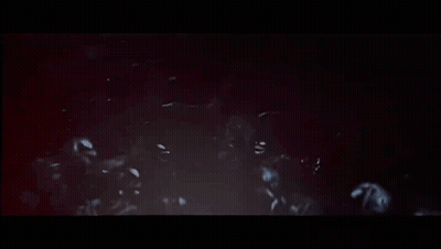 Skeletons In Dark Room With Arms Outstretched GIF