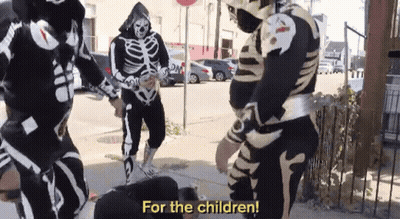 Skeletons Standing On Sidewalk Saying For The Children GIF