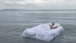 Sleeping Man Floating On The Ocean GIF