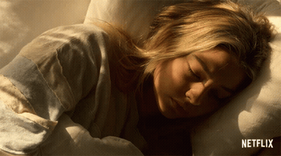 Sleeping Woman In Bed With Netflix Logo GIF