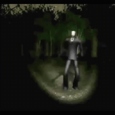 Slender Man Standing In Woods At Night GIF