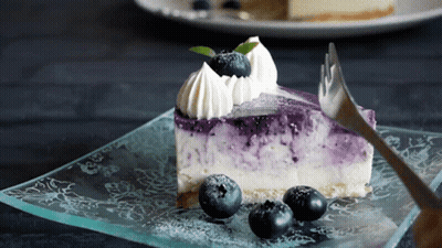 Slice Of Blueberry Cheesecake With Whipped Cream And Blueberries GIF