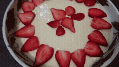 Sliced Strawberries On Top Of A Bowl Of Yogurt GIF