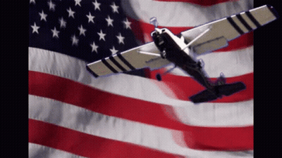 Small Airplane Flying In Front Of American Flag GIF