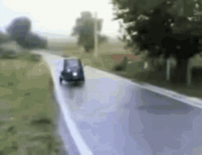 Small Car Driving Down Road GIF